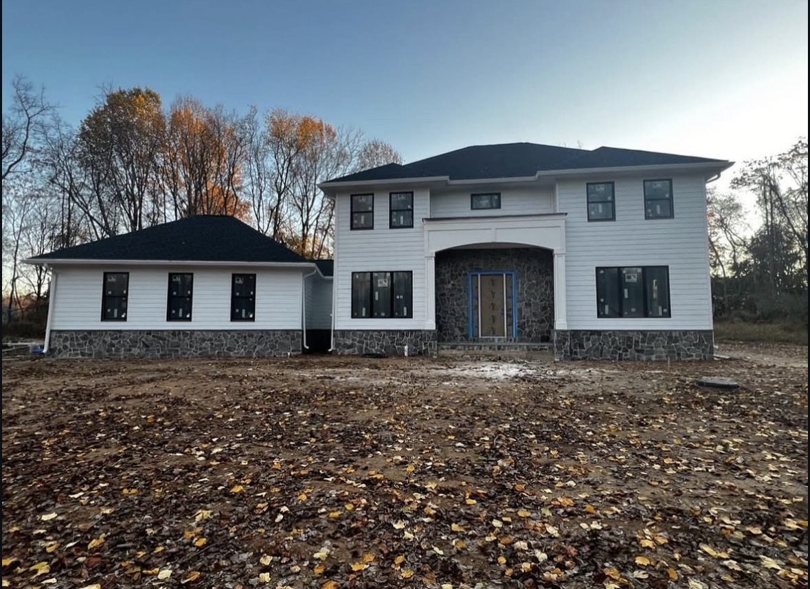 Newly built white siding and stone craftsman residence in Gaithersburg, MD
